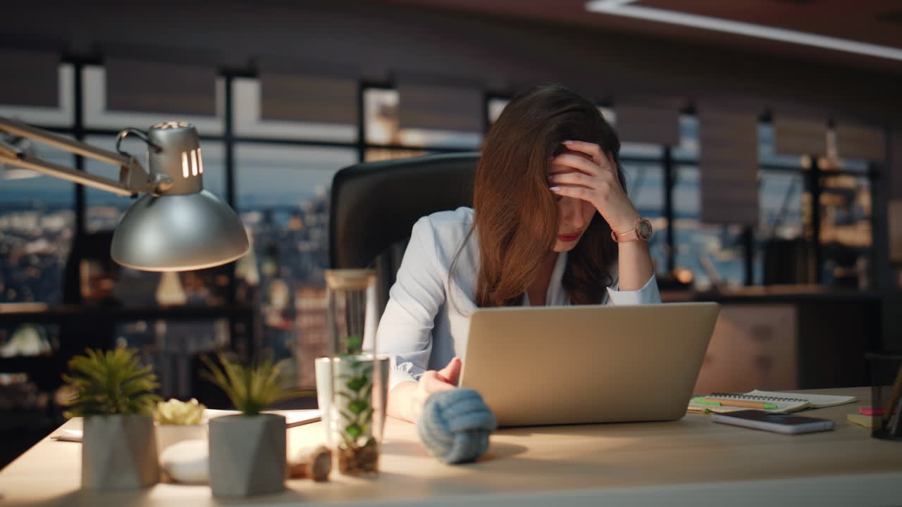 Disappointed business woman nervous dark office closeup. Lady making face palm
