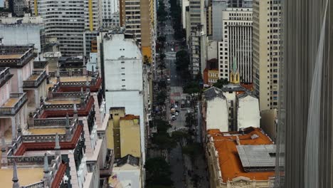 aerial-tilt-up-revealing-a-stone-jungle-and-wide-avenue-in-Sao-paulo-city,-Brazil