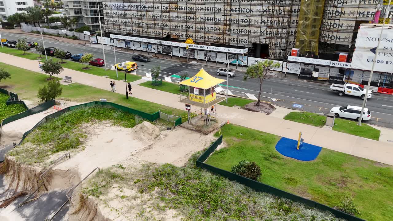 Aerial view of coastal erosion affecting beachfront infrastructure in Gold Coast, Australia. Overcast lighting highlights environmental changes