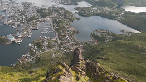 revealing aerial shot of svolvær in lofoten, norway from mountain top, fløya and djevelporten drone footage