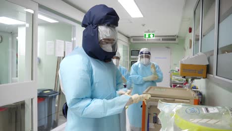 medic staffs putting on papr suits before entering covd-19 ward