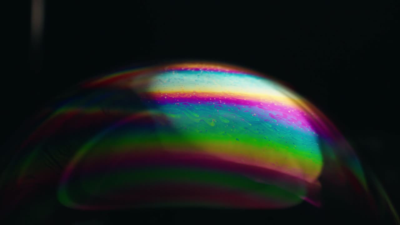 Close-up view of a beautiful rainbow-colored soap bubble on direct light, Canada.