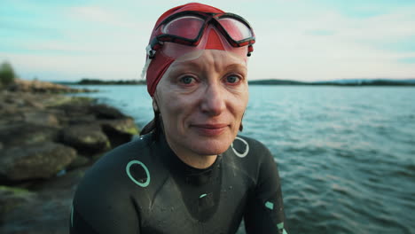 portrait of female triathlete on lakeshore