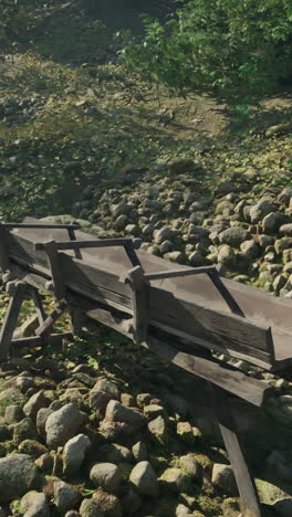 old wooden trough in a stone-covered area