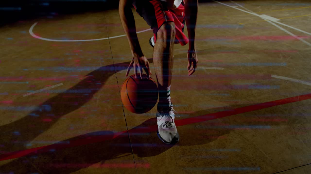 Male basketball player starting low dribble near red court line, practicing footwork with ball