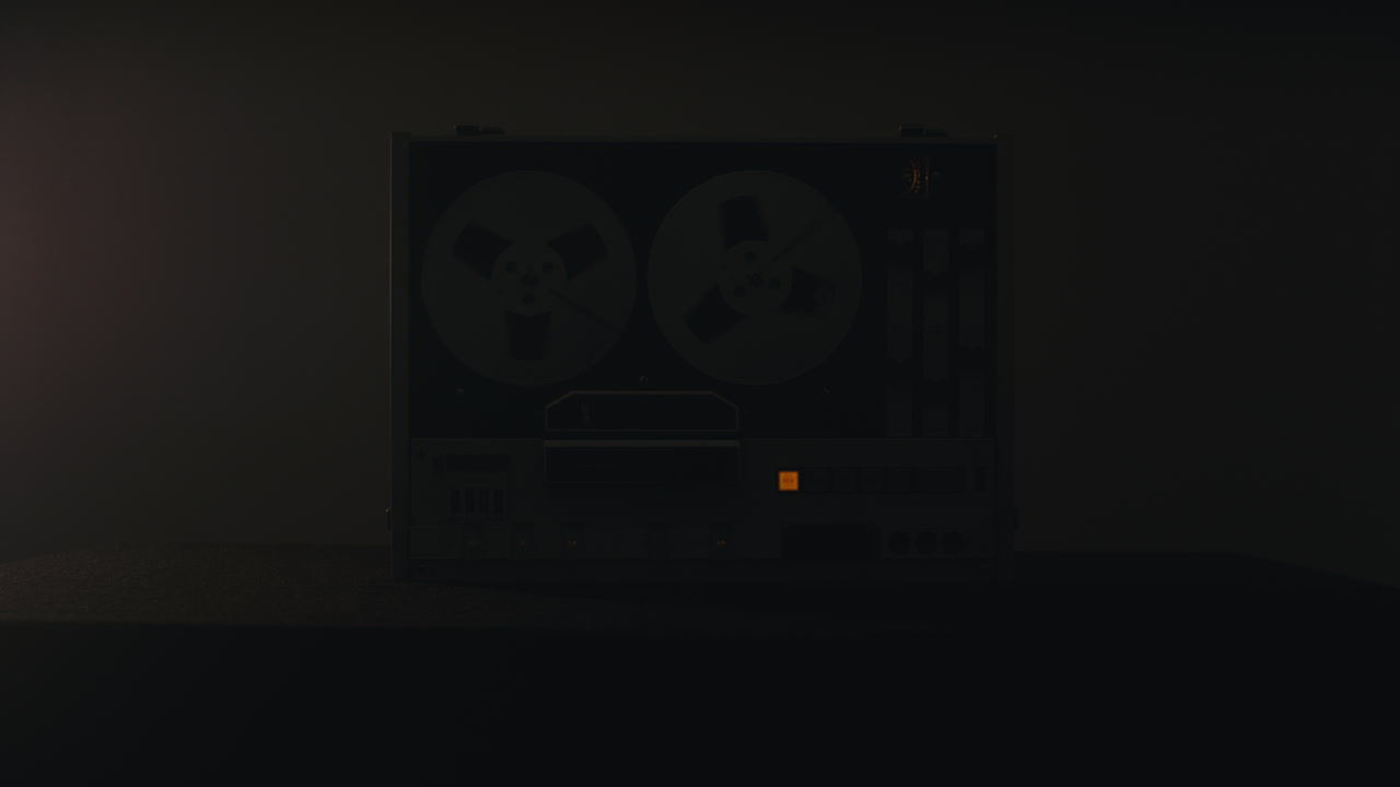 A vintage tape recorder in a pulsing light