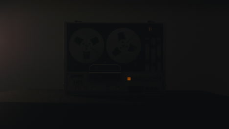 a vintage tape recorder in a pulsing light