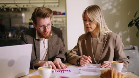 two businesspeople reviewing data at a meeting