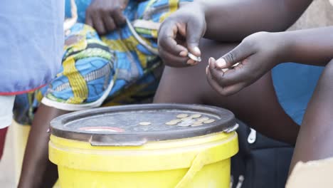 medium shot of an african person counting coins