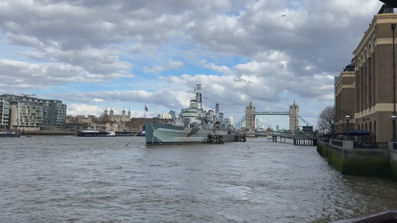 Historic ship and Tower Bridge with cloudy sky on the Thames River