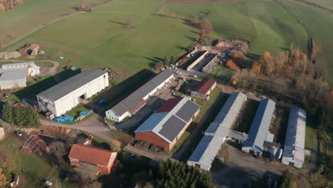 photovoltaic panels mounted on roof of farm which uses green and clean energy they produce, aerial view