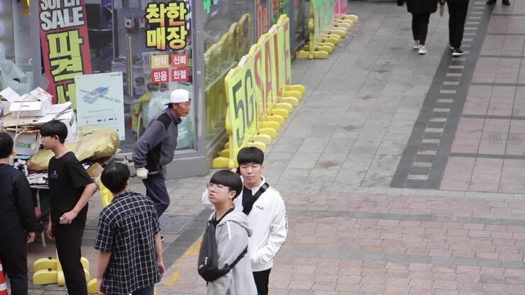Street scene in South Korea, with a man pushing a cart full of recyclables