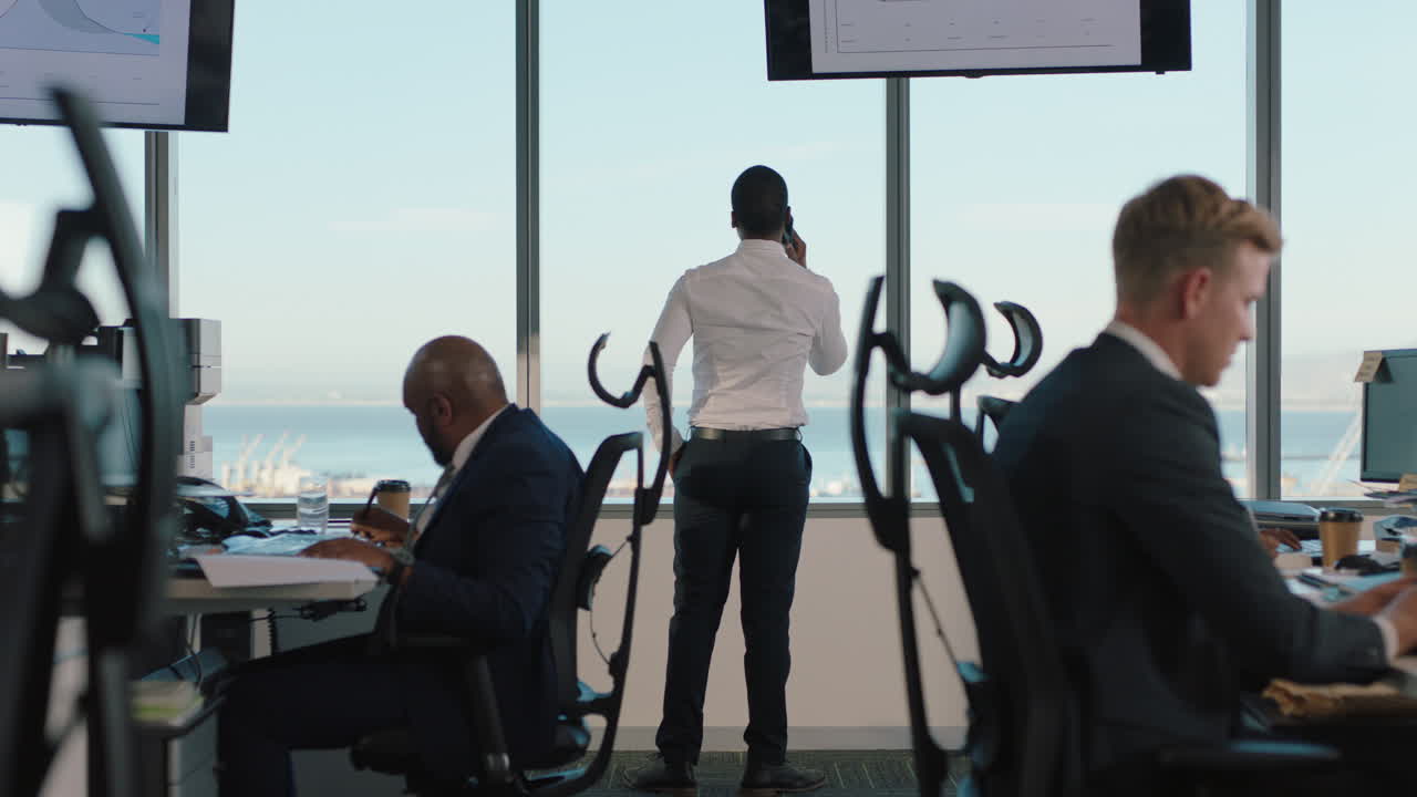 스마트폰 을 사용하는 사업가 가 휴대전화 로 고객 과 채팅 하고 창문 밖 을 바라보는 남자 경영자 가 바쁜 사무실 에서 판매 를 논의 하고 있다