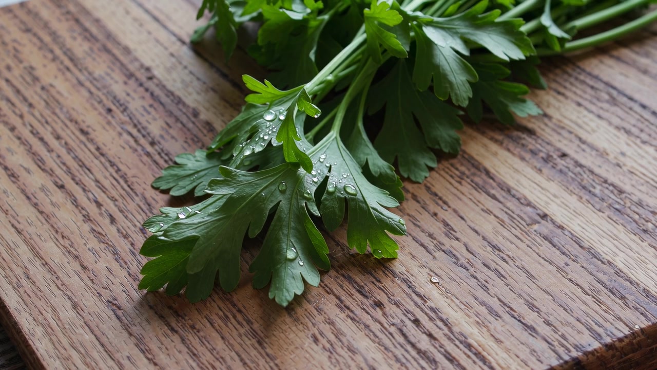 Fresh Green Parsley Sprigs on a Wooden Cutting Board