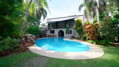 large tropical pool with spa grassy lawn under shade canopy with mediterranean entrance. exterior of house home for real estate property.