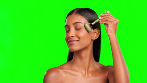 happy woman, face roller and beauty on green