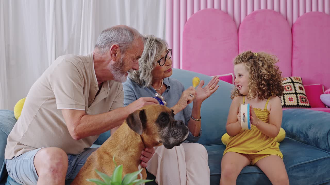 Family fun with grandparents, grandchild, and dog enjoying music together at home