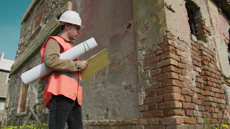 engineer using the pen to take notes about the old building