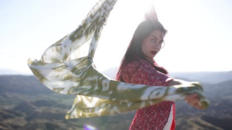 woman with a flowing scarf in a desert landscape