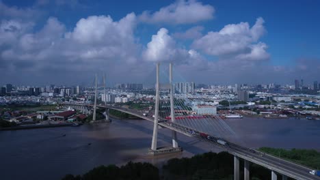 aerial view of phu my bridge over saigon river with road and river transportation on a sunny day