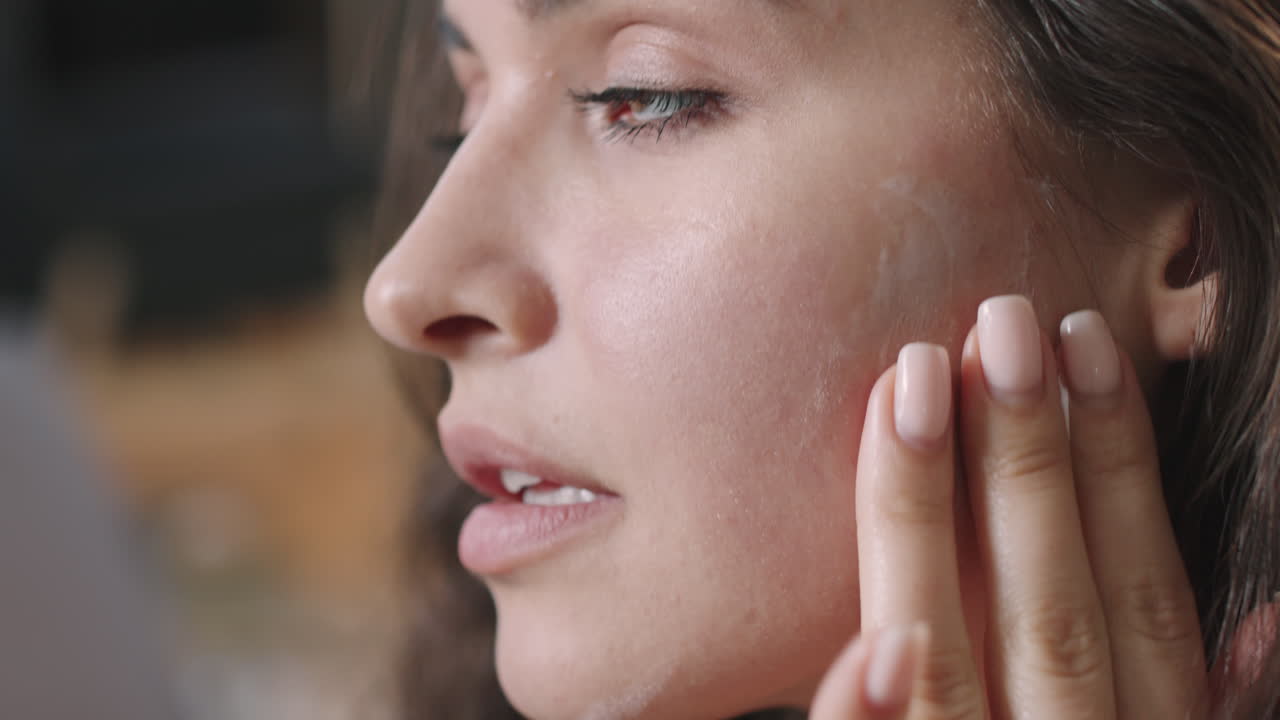 Beautiful Woman Applying Cream On Face