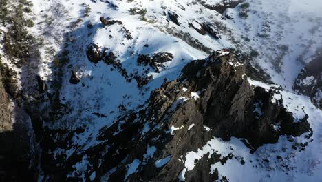 A-man-is-walking-alone-on-the-very-steep-and-dangerous-edge-of-a-cliff-on-the-mountain-Pico-Ruivo-in-Madeira