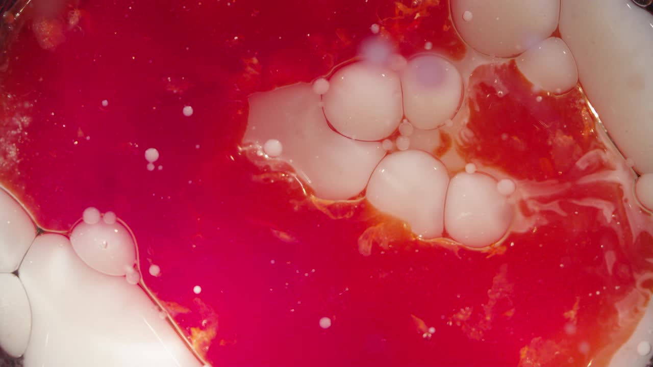 Abstract macro white bubbles sinking into red lava liquid background texture
