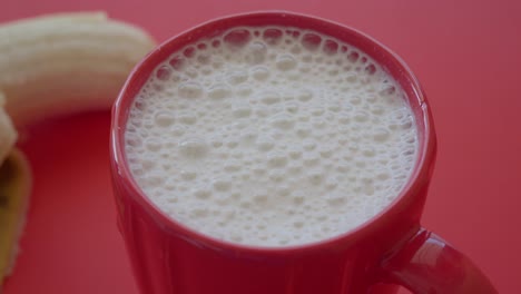 banana smoothie in red mug