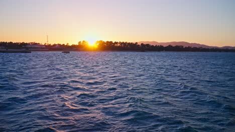 Slow-motion-waves-at-sunset,-handheld