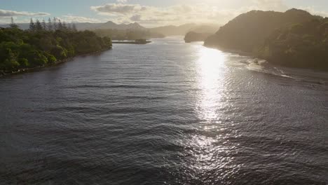 drone captures serene river and landscape during sunset, highlighting tranquil waters and lush greenery