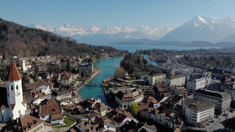 aerial view of an old authentic city of switzerland with beautiful alps and lake background