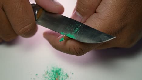 Footage-of-hands-slowly-sharpening-a-pencil-and-some-coloured-pencils-with-a-sharp-knife