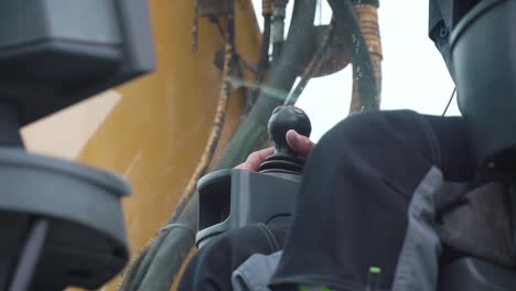 excavator operator using joystick controls