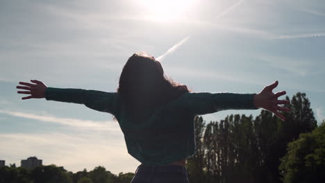 Gorgeous-Italian-woman-with-arms-raised-looking-at-Sunset-view-over-the-lake