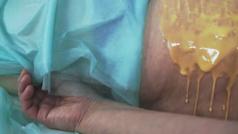 plump lady patient undergoes honey massage procedure closeup