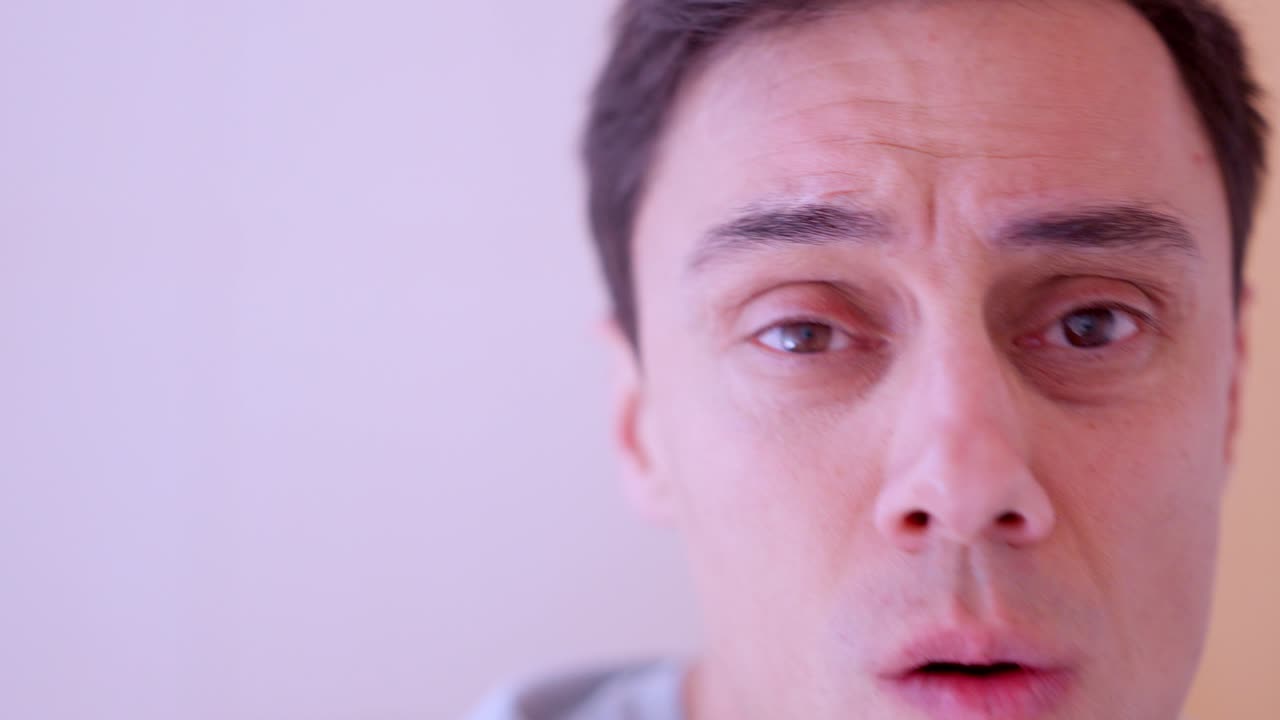 Man removing eyebrow and nose hair with electric trimmer