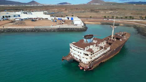 Great-aerial-view-flight-aground-Crude-oil-tanker-Shipwreck-on-beach-sandbank-Lanzarote-Canary-Islands,-sunny-day-Spain-2023