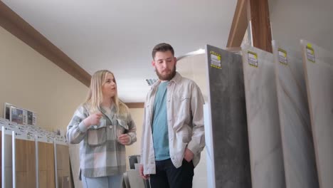 couple choosing tiles in a home improvement store
