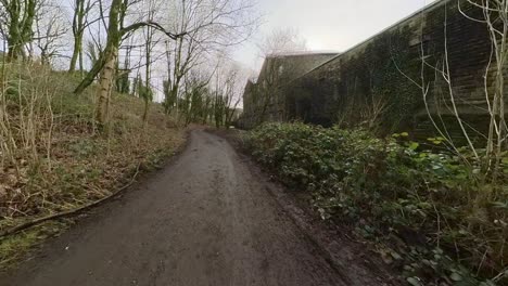 small country path running through the town of delph near oldham lancashire, uk