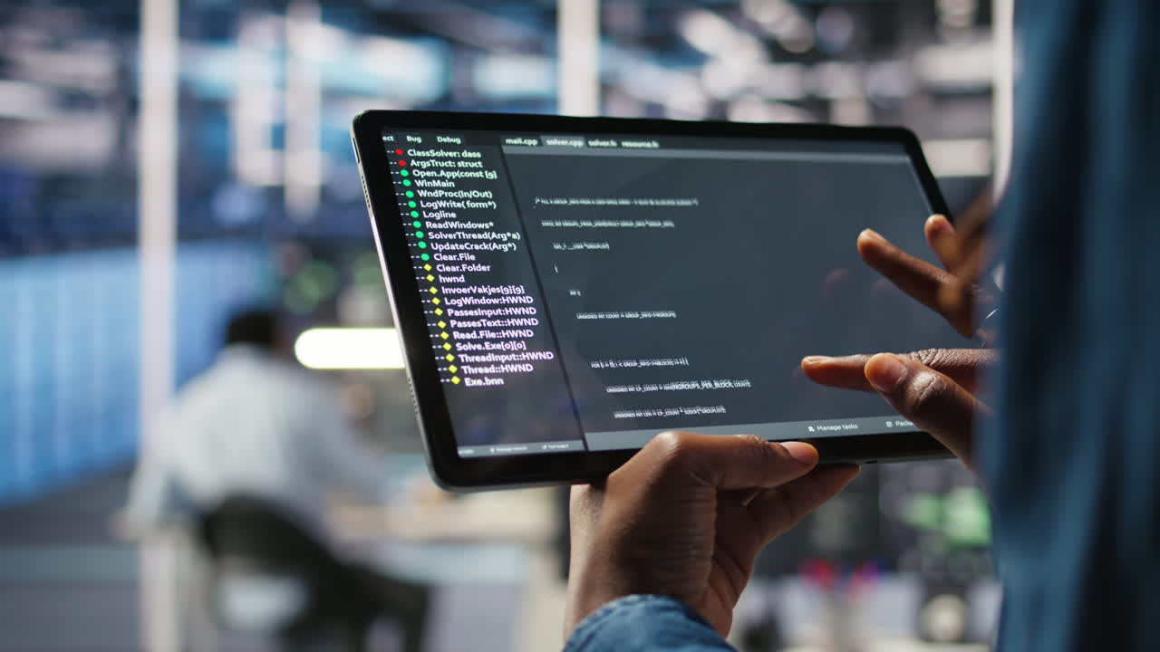 Close up of server room programmer checking coding on tablet