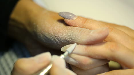 making perfect nail form. manicurist polishing fingernails with nail machine