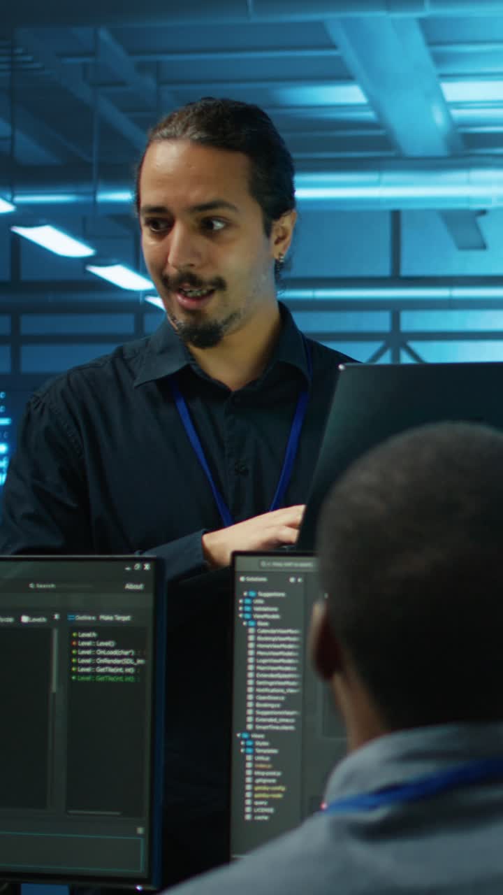 IT Engineer Coding on Laptop in Server Room
