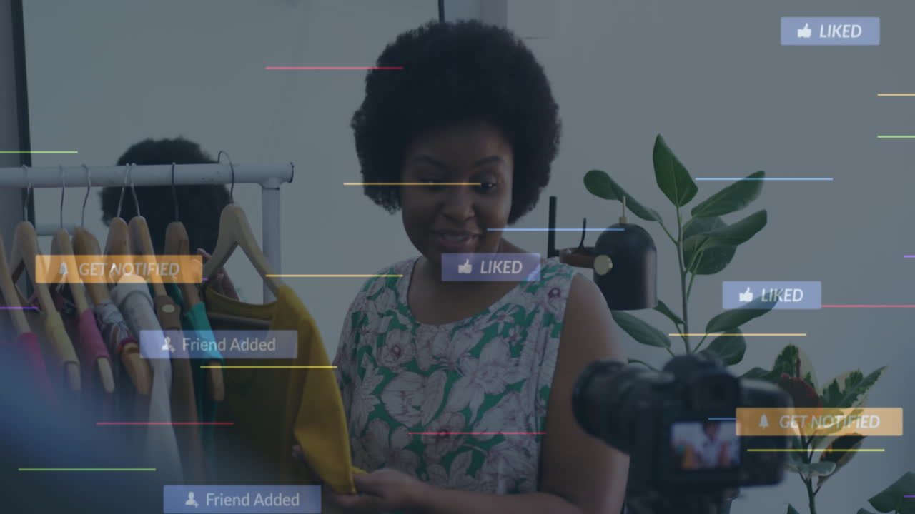 Animation of social media icons and data over african american woman in clothes shop