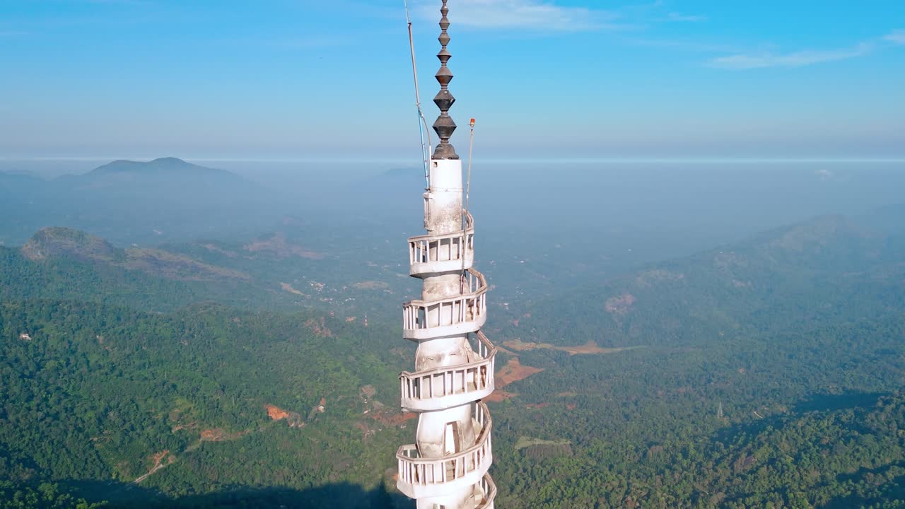 Experience the grandeur of Ambuluwawa Tower close to Kandy city at sunrise, captured from a drone.