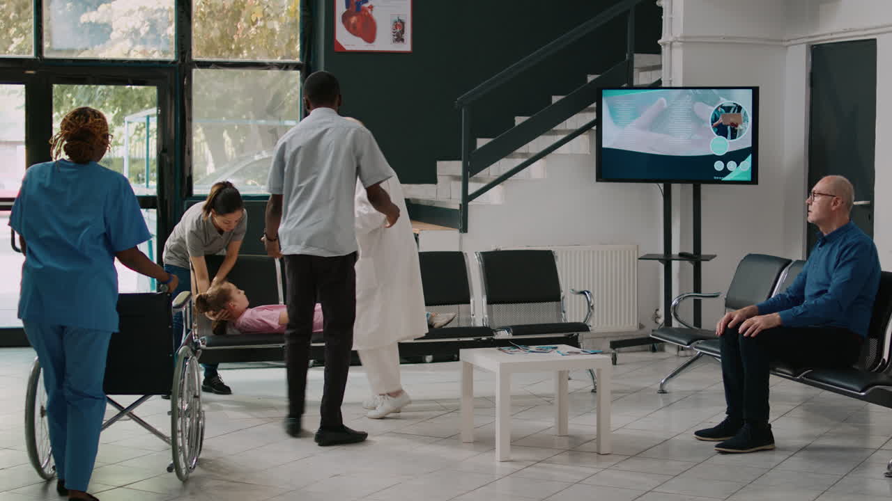 Father carrying unconscious kid in facility lobby to receive help