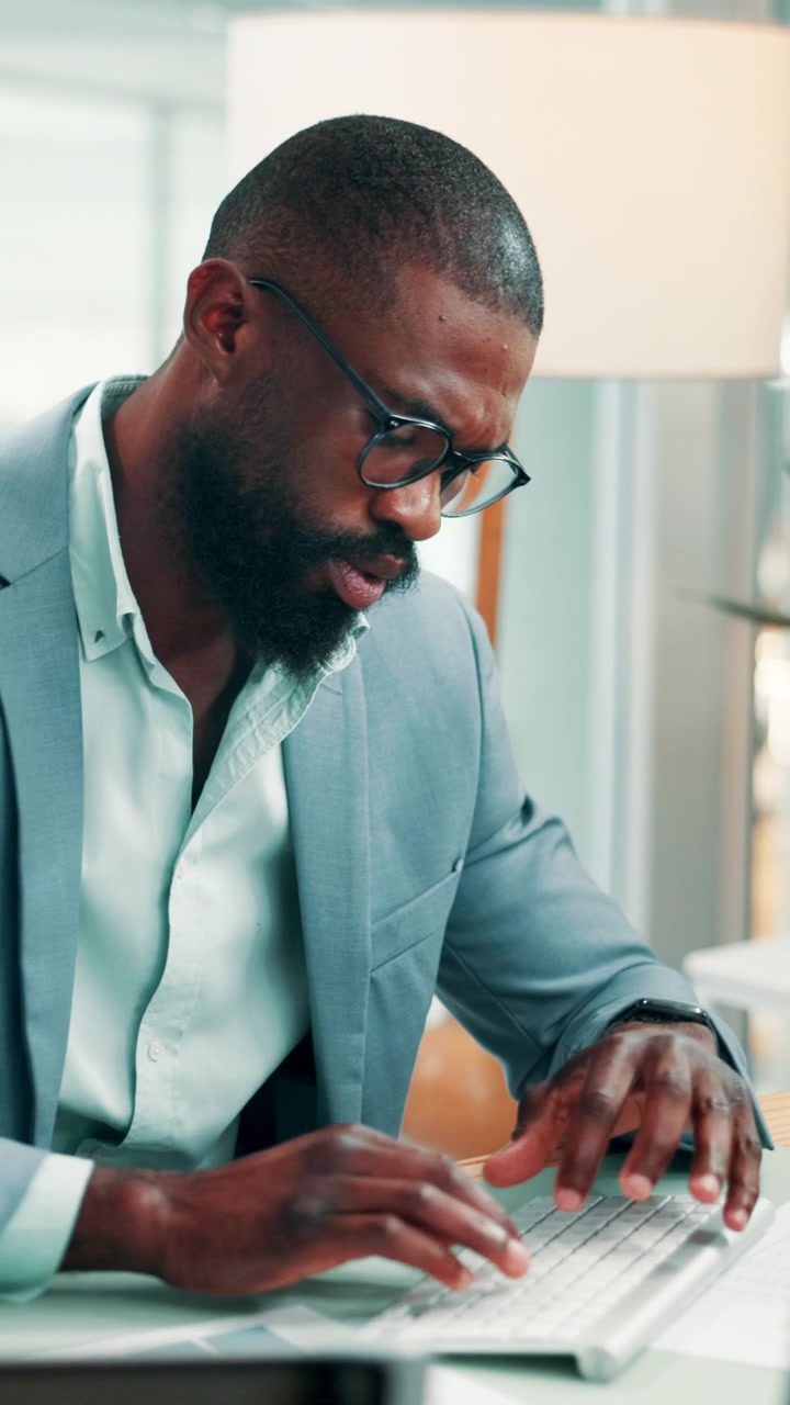 Focused Businessman Typing on Keyboard in Modern Office