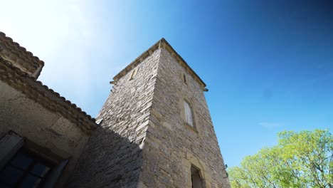 slow orbiting shot around a stone tower joined onto a luxury villa in nimes