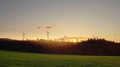 wind turbines in beautiful european nature during sunrise