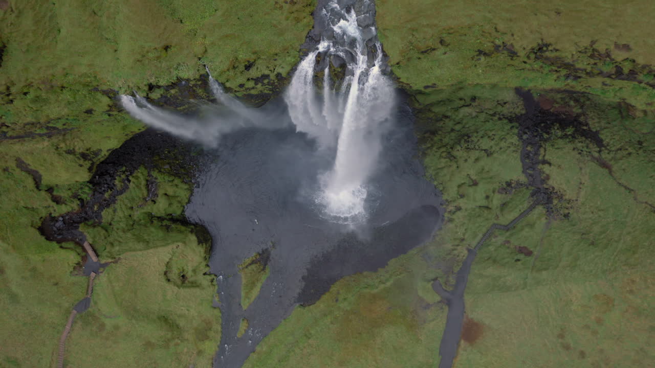 Aerial top down view and heading towards powerful Seljalandsfoss waterfall in Iceland