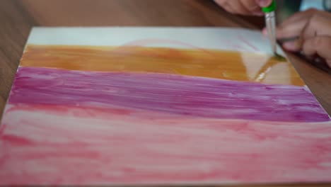 daughter doing her paint art at home using brushes